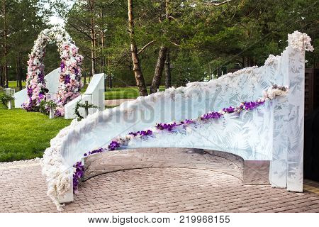 Outdoor wedding ceremony with umbrellas in the forest.