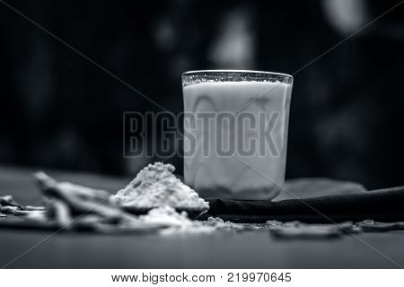 Close Up Of Ayurvedic Herb   Satavari,asparagus Racemosus With Its Powder And Root With Milk Glass.