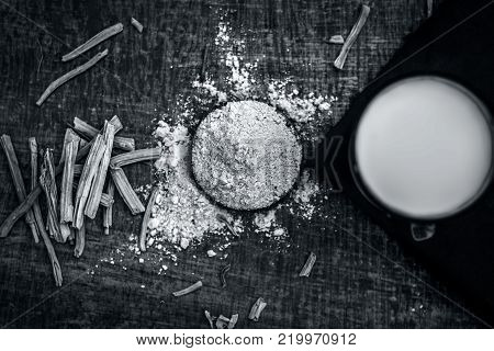 Close Up Of Ayurvedic Herb   Satavari,asparagus Racemosus With Its Powder And Root With Milk Glass.