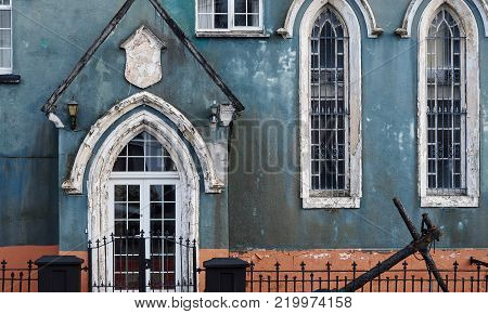 Old and worn out blue church in Clifden, Ireland