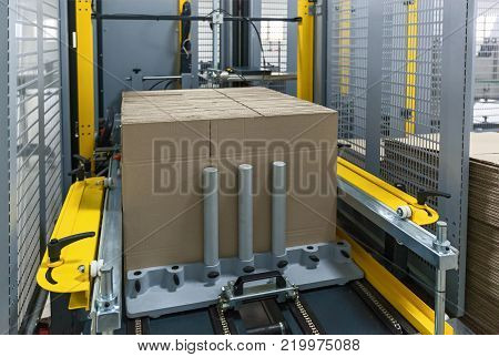 Strapping Machine for Industrail Packaging Line, Modern machine for packaging line in factory, Industrial and technology concept.