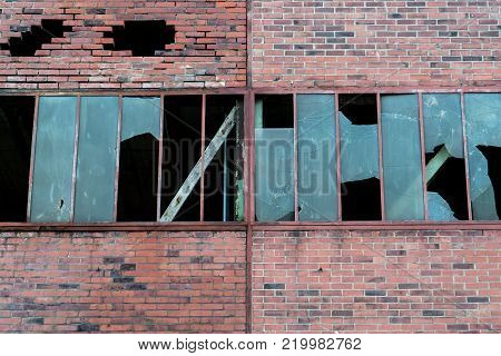 Red brick walls and destroyed green windows