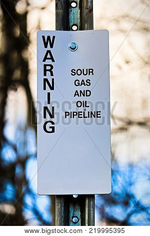 Warning sour gas and oil pipeline sign.