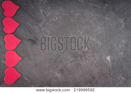 Pink hearts on a gray background. The symbol of the day of lovers. Valentine's Day. Concept February 14