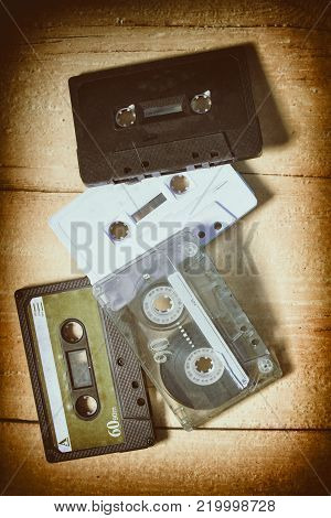 Old music cassettes on a wooden table