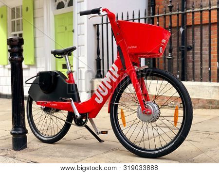 LONDON, UK - AUGUST 21, 2019: A Jump dockless electric bicycle parked on the pavement in a street in North London, UK.