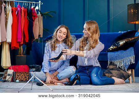 Two Handsome Young Woman Discussing Trends Shoes.