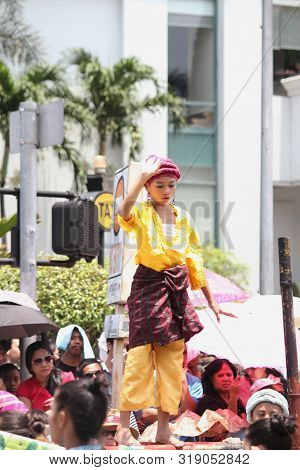 Davao City, Philippines-august 2014: A Girl Balances Herself On A Bamboo Pole At The Streetdancing C