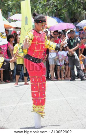 Davao City, Philippines-august 2014: A Girl In Parade Costumes Balances Herself On A Small Pole At T