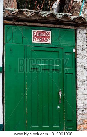 Mongui, Colombia - August, 2019: Old Door In Mongui In Which You Can Read Ball Cradle