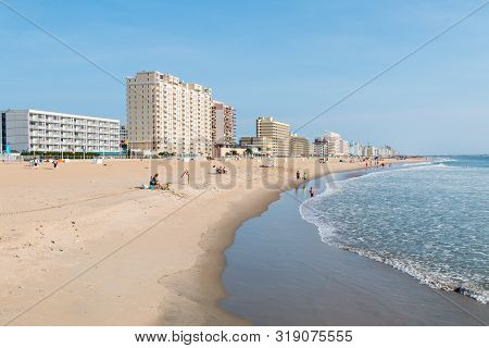 Virginia Beach, Virginia/usa - July 13, 2017:  Hotels Line The Oceanfront Boardwalk And People Enjoy