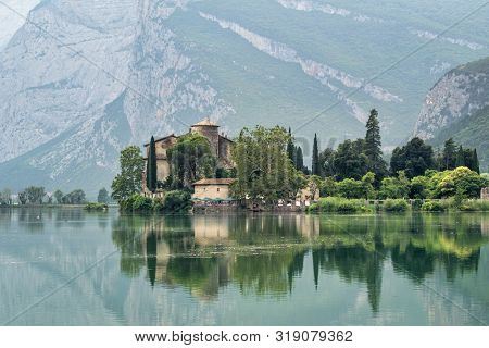 Castel Toblino, Italy - July 25, 2019 : The Reflections Of Tobilino Castle In The Trento Region Of I