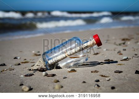 A Washed-up Bottle Post On The Beach