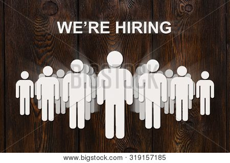Paper Men On Wooden Background With Text We're Hiring