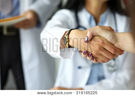 Arm Of Female Gp Shaking Hands With Visitor Close-up. Self Introduction Cheering Or Problem Solution
