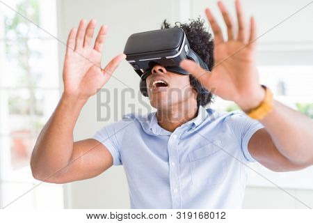 African amaerican man having fun playing with virtual reality glasses