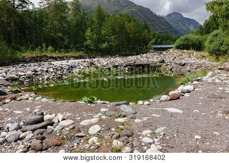 A Small Lake In The Middle Of A Stone Path Somewhere In The Forest