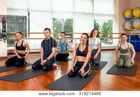 Happy Multiracial Group Of Young, Smiling Beautiful Girls And Panes In Sportswear, Doing Yoga Exerci