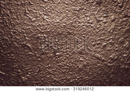 Brown Rough Concrete Painted Wall. Grunge Background. Reflective On Raggy Surface. Dark Texture With