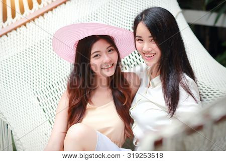 Young And Cute Asian Women With Hat Lying In A Hammock During Holiday