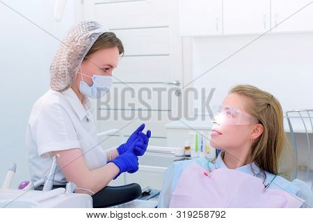 Dentist Talks With Woman Patient On Preventive Examination Stomatology Clinic. Doctor Stomatologist 
