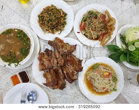 Thai Food Style, Top View Of Papaya Salad Set, Spicy Minced Fish Salad, Grilled Chicken, Pork Spare 