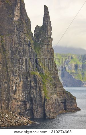 Stack In Faroe Islands, Sandavagur. Trollkonufingur In Vagar Island Coastline.