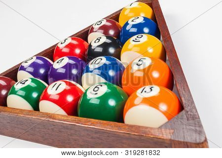 Close up of pool balls in a triangle on a whhite background
