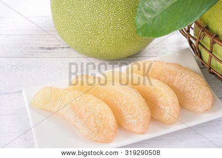 Fresh Peeled Pomelo, Grapefruit, Shaddock With Green Leaf On Bright Wooden Plank Table. Seasonal Fru