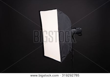 A Softbox On The Black Background. A Professional Stripbox. Photo Studio Equipment.