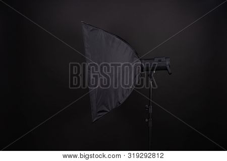 A Softbox On The Black Background. A Professional Stripbox. Photo Studio Equipment.