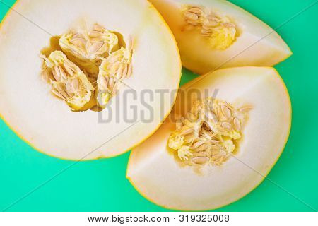 Ripe Juicy Cut Melon On A Green Background. Harvest Concept, Vitamin Organic Food. Minimalism, Top V