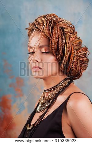 Southern Flavor. Portrait Of A Luxurious Tanned Woman, Pensive, Stylish, With An Exotic Hairstyle An
