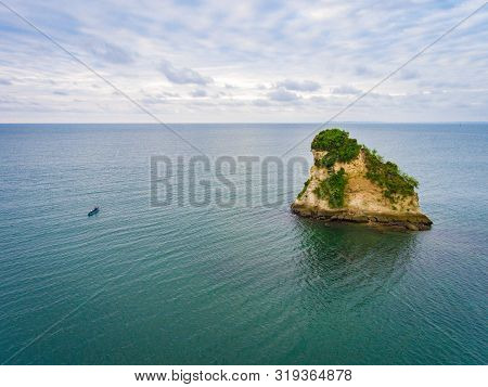 The Small Quesillo Island And A Boat In The Pacific Ocean In Front Of The Tumaco Beach