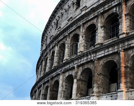 Colosseum In Rome Italy  Close-uo Across Blue Sky
