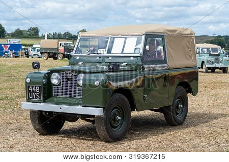 Haselbury Plucknett.somerset.united Kingdom.august 18th 2019.a Vintage Land Rover Is Being Driven At