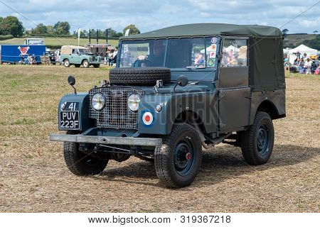 Haselbury Plucknett.somerset.united Kingdom.august 18th 2019.a Vintage Land Rover Is Being Driven At