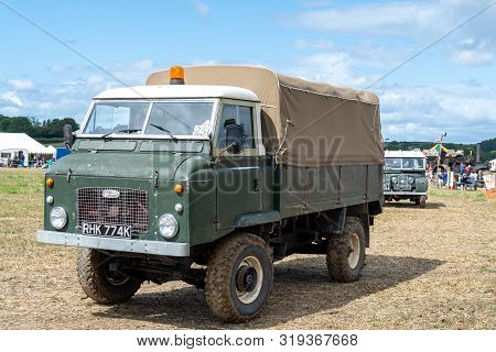 Haselbury Plucknett.somerset.united Kingdom.august 18th 2019.a Vintage Land Rover Is Being Driven At