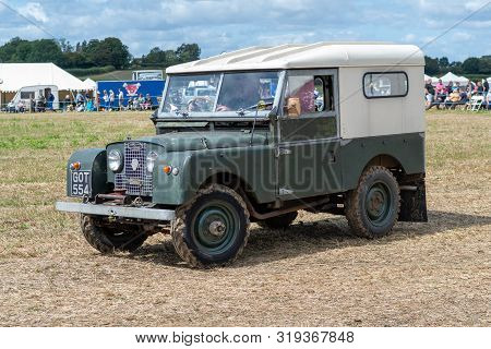 Haselbury Plucknett.somerset.united Kingdom.august 18th 2019.a Vintage Land Rover Is Being Driven At
