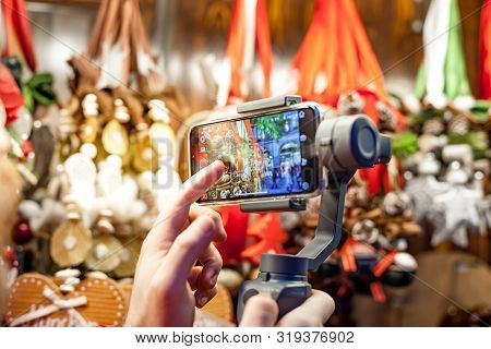 Germany, Munich - December 20, 2018: Close-up Of Man Blogger Hands Shooting Video On Smartphone Ipho