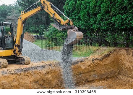 A Yellow Excavator Bucket Shovel Moving Gravel Stones Of Foundation On A Construction Site Stone Bac