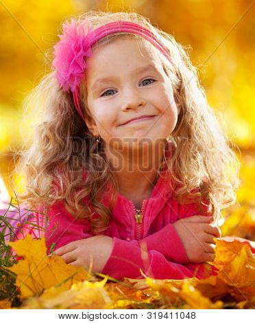 Happy little child in autumn park
