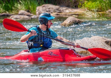 Myhiya, Ukraine - August 17, 2019: Playboating. A Man Sitting In A Kayak With Oars In His Hands Perf