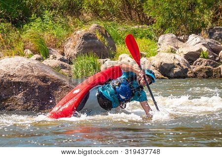 Myhiya, Ukraine - August 17, 2019: Playboating. A Man Sitting In A Kayak With Oars In His Hands Perf