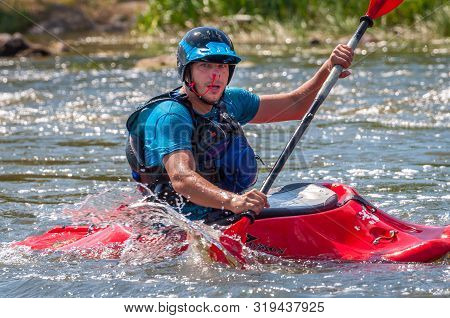 Myhiya, Ukraine - August 17, 2019: Playboating. A Man Sitting In A Kayak With Oars In His Hands Perf