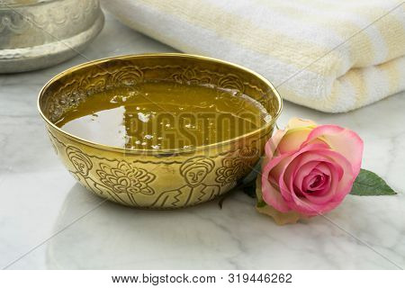 Savon noir, black soap, with rose extract and fresh pink rose in hammam