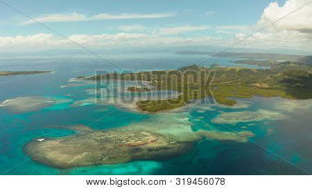 Tropical Landscape: Islands And Atolls With Blue Water Against The Sky And Clouds. Bucas Grande, Phi