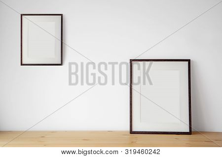 Blank Black Picture Frame On The White Wall And The Wooden Floor, Template Poster Interior Photo 3d 