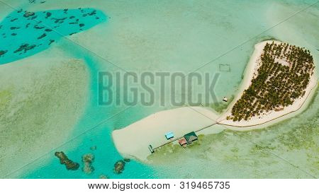 Tropical Island Among Coral Reefs With A White Beach And Blue Atoll Water. Onok Island, Balabac, Phi