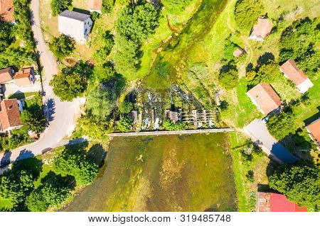 Tonkovic Vrilo, River Source Of Gacka And Wooden Bridge Over The River, Aerial View, Lika Region Of 